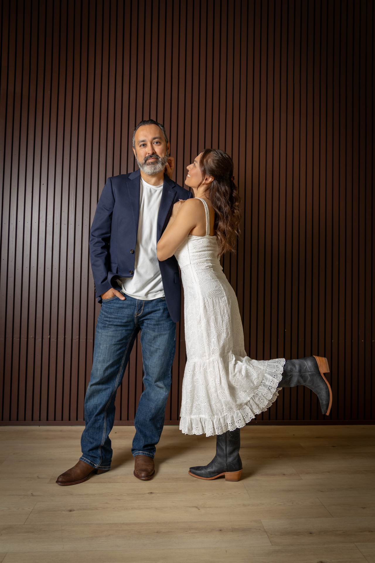 couple posing wearing cowboy boots 